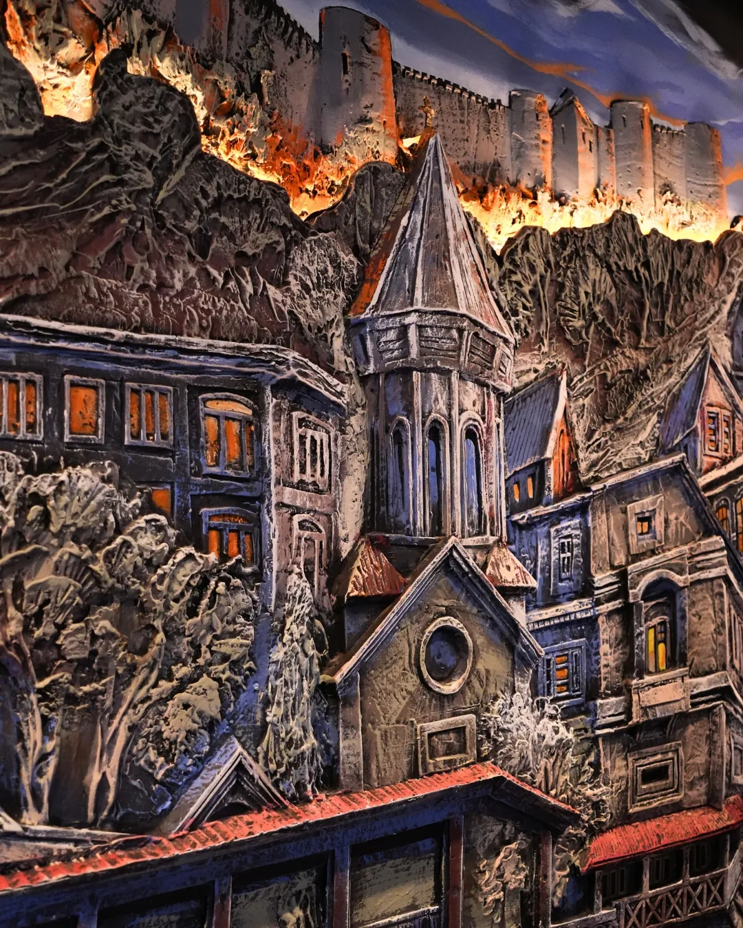 Hand-sculpted relief wall of old Tbilisi with warm backlight